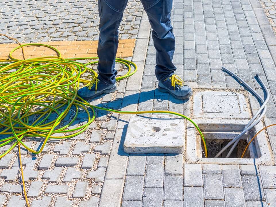 Suncoast Energy technician prepares electrical cables for underground power install